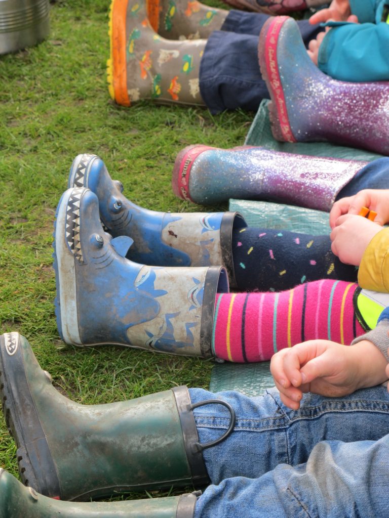 Welly boots on a row of children.