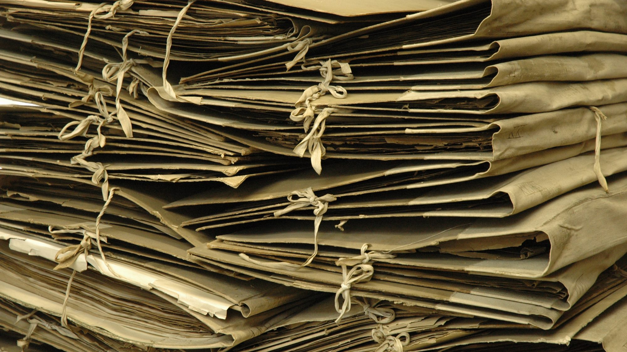 A pile of folded fabric cases that surround herbarium samples