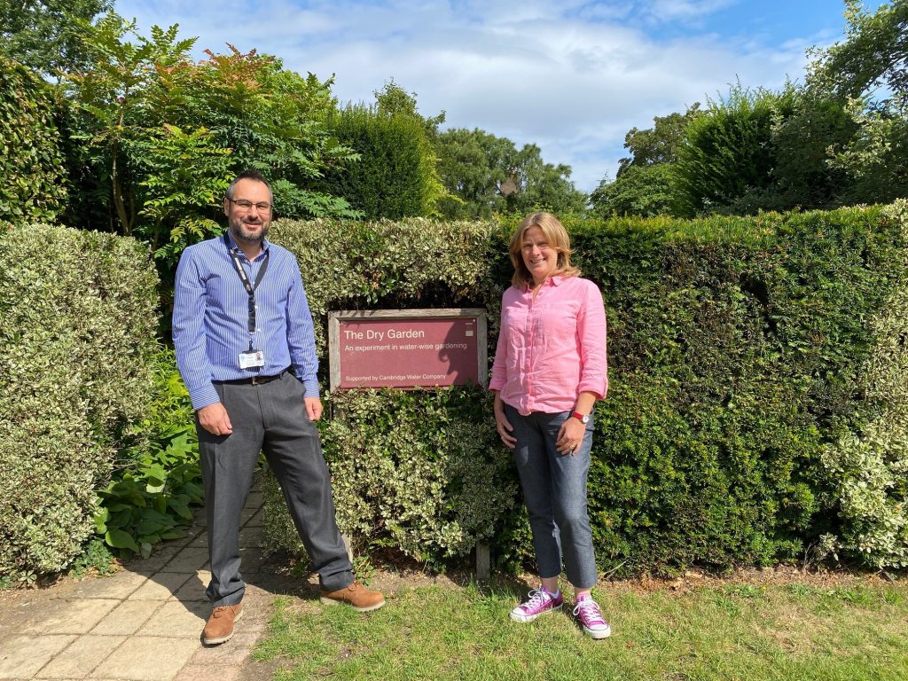 Representatives of the Garden and Cambridge water in front of the Dry Garden sign