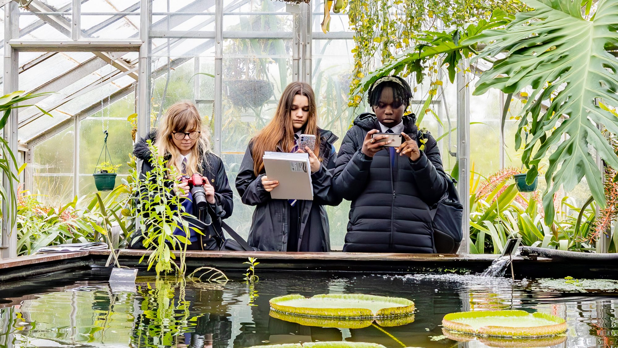 Secondary students photographing Glasshouse plants