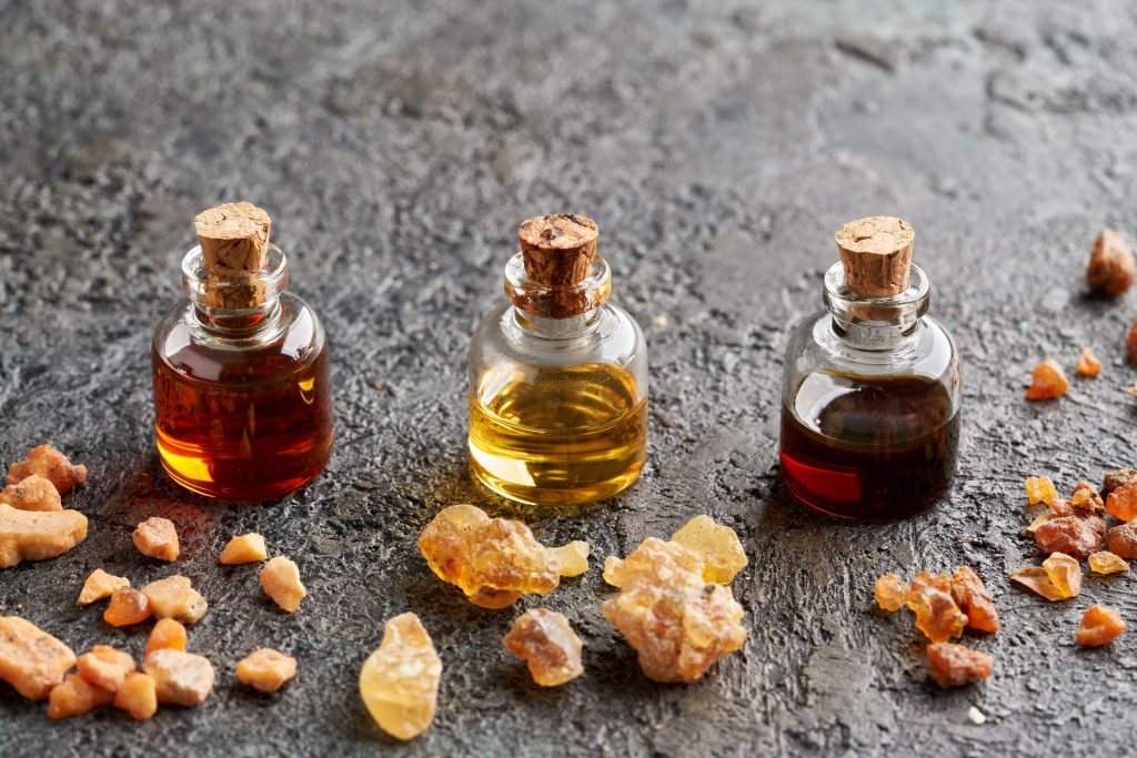 three small bottles with cork stoppers and liquid inside