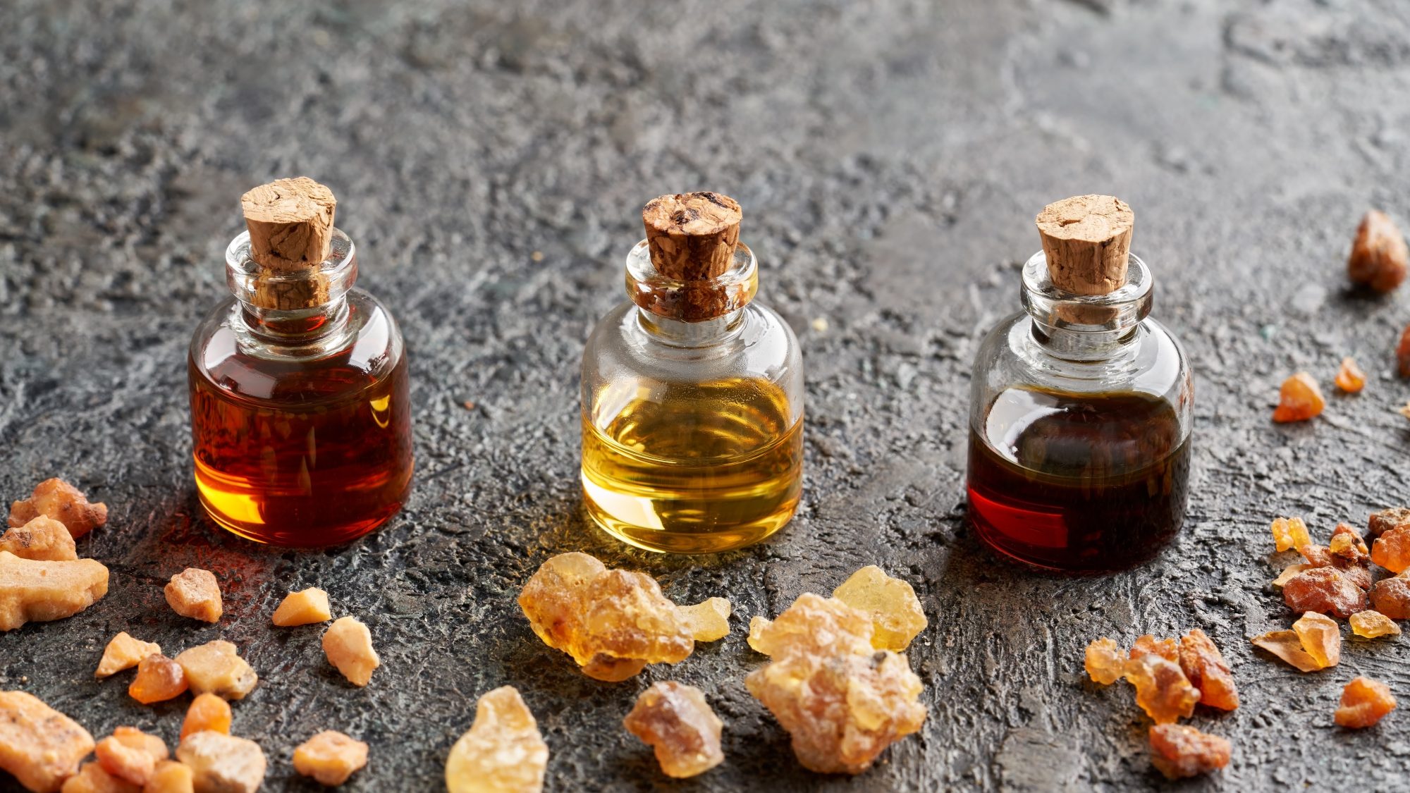 three small bottles with cork stoppers and liquid inside