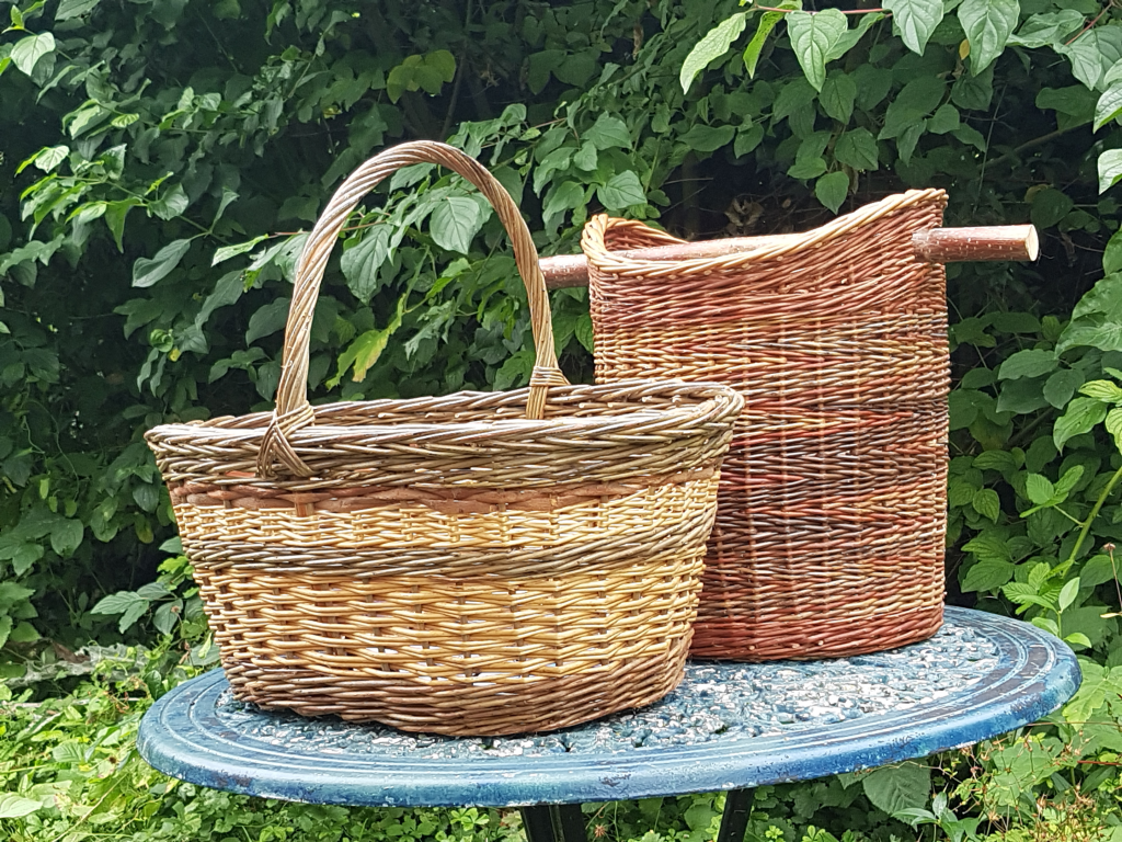 two hand woven baskets on a garden table