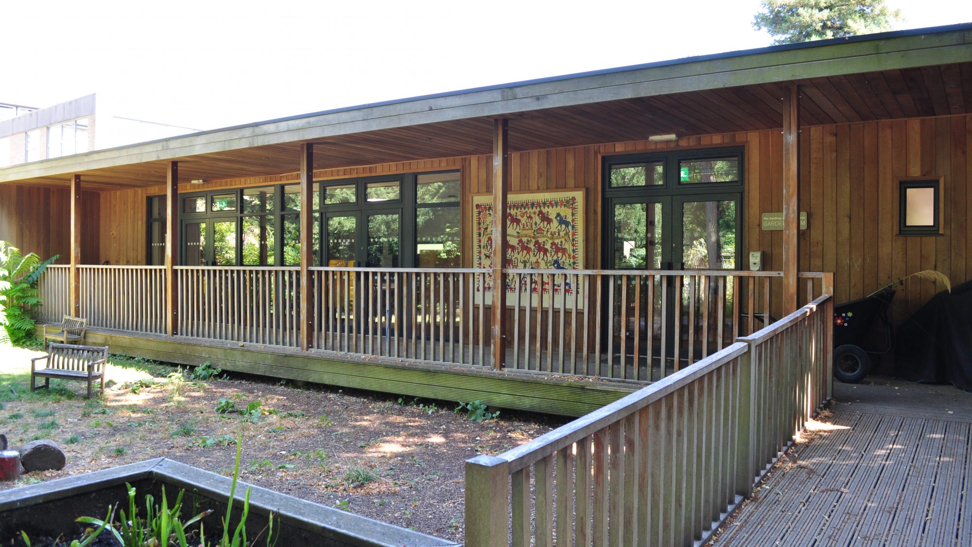 The Geoffrey and Eileen Adams Garden room. A single story wooden building with a covered verandah