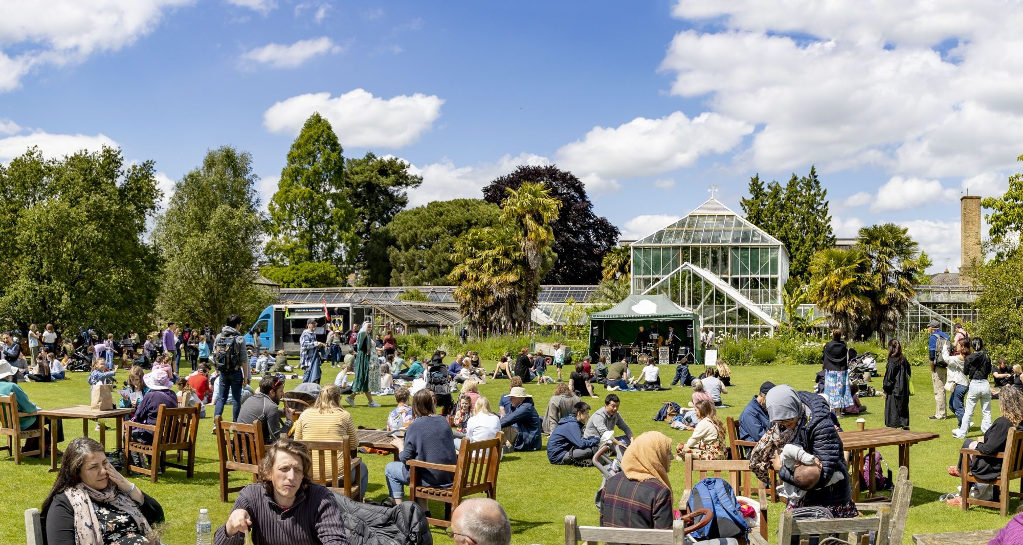 A view of the main lawn with food trucks, tents and visitors.