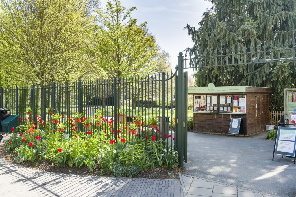 CUBG entrance shown with a shed serving as a ticket office with a poster in front of it and a noticeboard to the side