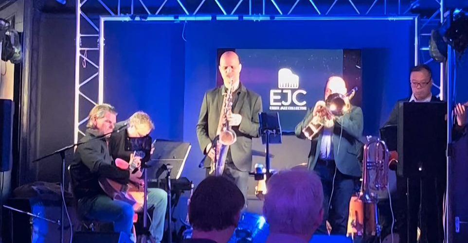 Jazz band playing on stage with blue lighting